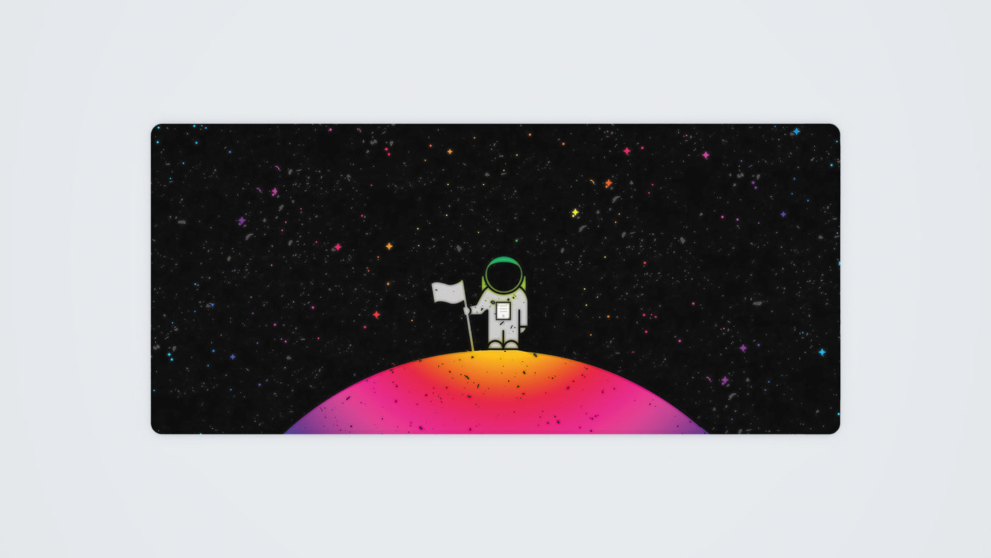 900 x 400 mm custom gaming mouse mat with a cartoon astronaut standing on a planet, in a spectrum of dark and RGB colours